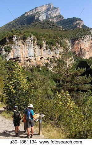 Hikers walking in Aisclo Valley, canyon belonging to Ordesa y Monte Perdido National Park Pyrenees Fanlo Huesca province Arag? n Spain View Large Photo Image Picture - Hikers walking in Aisclo Valley, canyon belonging to Ordesa y Monte Perdido National Park Pyrenees Fanlo Huesca province Arag? n Spain. Fotosearch
