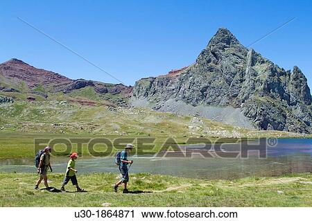 Hikers walking to Anayet peak an old volcano, next to Anayet lakes, in Tena valley Formigal Sallent de GBllego Pyrenees Huesca province Arag? n Spain View Large Photo Image Stock Image - Hikers walking to Anayet peak an old volcano, next to Anayet lakes, in Tena valley Formigal Sallent de GBllego Pyrenees Huesca province Arag? n Spain. Fotosearch