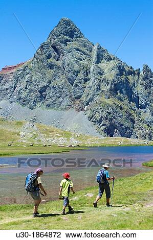 Stock Image - Hikers walking to Anayet peak an old volcano, next to Anayet lakes, in Tena valley Formigal Sallent de GBllego Pyrenees Huesca province Arag? n Spain. Fotosearch