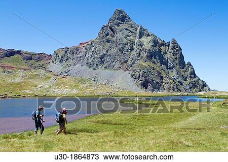 Hikers walking to Anayet peak an old volcano, next to Anayet lakes, in Tena valley Formigal Sallent de GBllego Pyrenees Huesca province Arag? n Spain View Large Photo Image Stock Image - Hikers walking to Anayet peak an old volcano, next to Anayet lakes, in Tena valley Formigal Sallent de GBllego Pyrenees Huesca province Arag? n Spain. Fotosearch