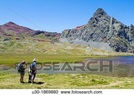 Hikers walking to Anayet peak an old volcano, next to Anayet lakes, in Tena valley Formigal Sallent de GBllego Pyrenees Huesca province Arag? n Spain View Large Photo Image Stock Image - Hikers walking to Anayet peak an old volcano, next to Anayet lakes, in Tena valley Formigal Sallent de GBllego Pyrenees Huesca province Arag? n Spain. Fotosearch