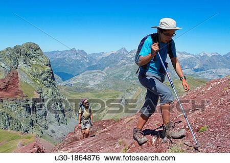 Stock Photograph - Hikers walking to summit of Anayet, an old volcano in Tena valley Formigal Sallent de GBllego Pyrenees Huesca province Arag? n Spain. Fotosearch