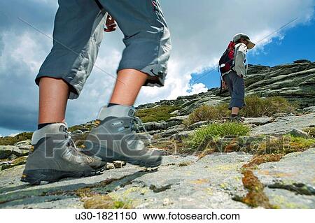 Stock Image - Hikers walking to Torozo peak in Sierra de Gredos? vila province Castilla y Le? n Spain. Fotosearch