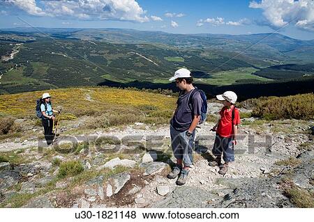 Stock Photo - Hikers walking to Torozo peak in Sierra de Gredos? vila province Castilla y Le? n Spain. Fotosearch