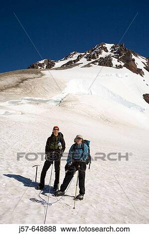 Stock Photo - Hiking and climbing in Glacier Peak Wilderness. Washington USA. Approaching the summit of glacier peak via the south ridge. Disapointment saddle.. Fotosearch