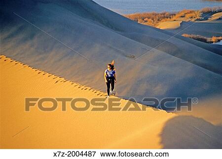 hiking the Bruneau Dunes during sunset at Bruneau Dunes State Park near the town of Bruneau in southern Idaho. View Large Photo Image Stock Photo - hiking the Bruneau Dunes during sunset at Bruneau Dunes State Park near the town of Bruneau in southern Idaho.. Fotosearch
