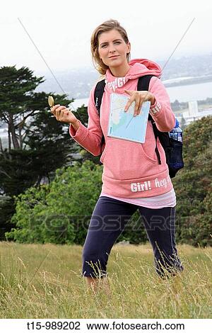 Stock Image - Hiking with compass and maps. Fotosearch