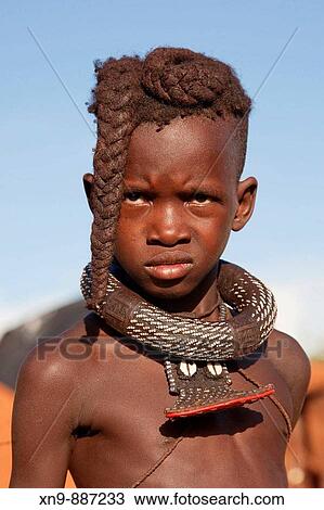 Himba boy with the typical double plait hairstyle, Epupa falls, Kaokoland, Namibia. View Large Photo Image Stock Image - Himba boy with the typical double plait hairstyle, Epupa falls, Kaokoland, Namibia.. Fotosearch