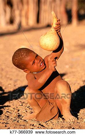 Himba child with pumpkin. Kaokoveld. Namibia. View Large Photo Image Stock Photo - Himba child with pumpkin. Kaokoveld. Namibia.. Fotosearch