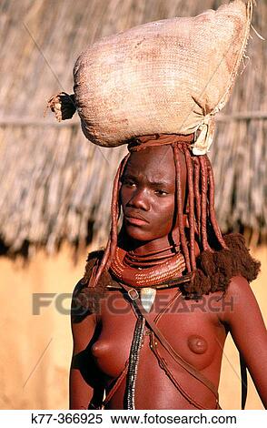 Himba wife carrying a flour bag on her head. Kaokoveld. Namibia. View Large Photo Image Stock Photography - Himba wife carrying a flour bag on her head. Kaokoveld. Namibia.. Fotosearch