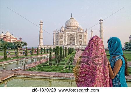 Stock Photo - Hindu women with colorful veils in the quiet peaceful Taj Mahal one of the wonders of the world in Agra India. Fotosearch