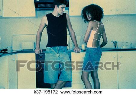 Hip couple making coffee in kitchen View Large Photo Image Stock Image - Hip couple making coffee in kitchen. Fotosearch
