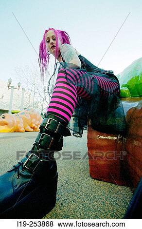 Stock Photo - Hip young woman with pink hair and tattoos. Fotosearch