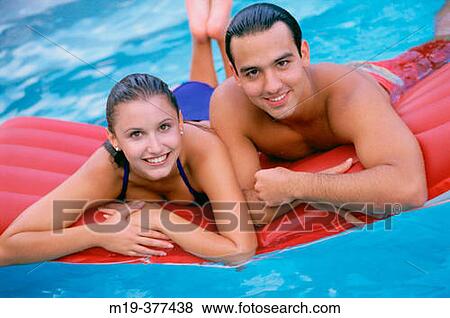 hisp. couple in a swiming pool View Large Photo Image Stock Photo - hisp. couple in a swiming pool. Fotosearch