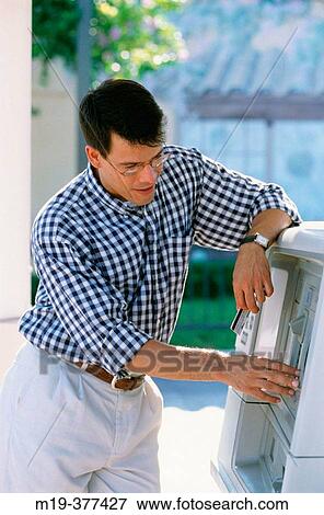 hisp man at a bank cash machine View Large Photo Image Stock Photo - hisp man at a bank cash machine. Fotosearch