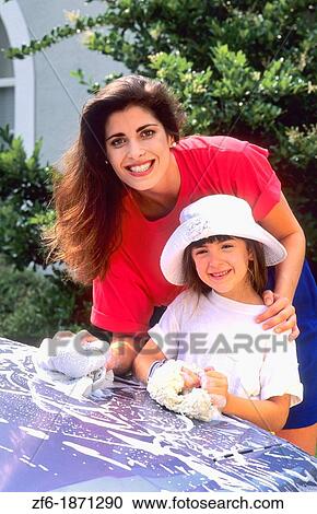 Hispanic beautiful colorful mother washing car with her young daughter together and laughing View Large Photo Image Stock Image - Hispanic beautiful colorful mother washing car with her young daughter together and laughing. Fotosearch