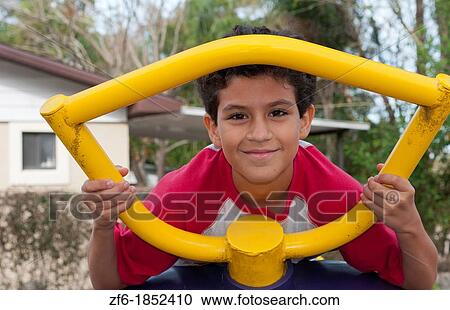 Hispanic boy aged 11 playing in playground on equipment portrait in park with colorful fun View Large Photo Image Stock Image - Hispanic boy aged 11 playing in playground on equipment portrait in park with colorful fun. Fotosearch