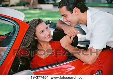 hispanic couple and a sports car View Large Photo Image Picture - hispanic couple and a sports car. Fotosearch