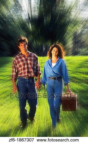 Hispanic couple outdoors going on picnic with basket together for fun View Large Photo Image Stock Photo - Hispanic couple outdoors going on picnic with basket together for fun. Fotosearch