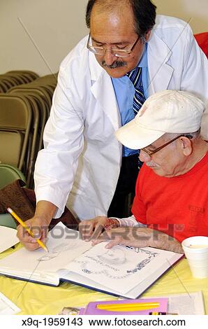 Hispanic elderly man receiving sketching lessons at the East Harlem Spanish Manhattan Seventh Day Adventist Church, East Harlem, Manhattan, New York City, USA. View Large Photo Image Stock Image - Hispanic elderly man receiving sketching lessons at the East Harlem Spanish Manhattan Seventh Day Adventist Church, East Harlem, Manhattan, New York City, USA.. Fotosearch