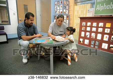 Stock Image - Hispanic family in clinic waiting room. Orange. California. USA. Fotosearch