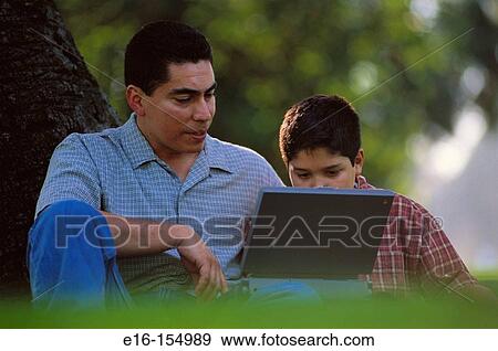 Hispanic father and son with laptop computer View Large Photo Image Stock Photo - Hispanic father and son with laptop computer. Fotosearch