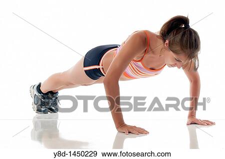 Stock Photo - Hispanic fitness woman exercising - Working out by doing push ups. Fotosearch