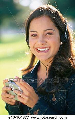 Hispanic girl listening to music View Large Photo Image Stock Photo - Hispanic girl listening to music. Fotosearch
