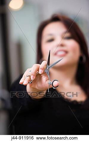 Hispanic hairdresser, holding scissors, smiling, portrait View Large Photo Image Stock Photograph - Hispanic hairdresser, holding scissors, smiling, portrait. Fotosearch