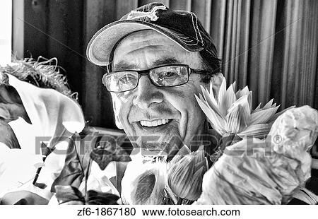 Hispanic man with glasses holding flowers in Havana Habana Cuba View Large Photo Image Stock Image - Hispanic man with glasses holding flowers in Havana Habana Cuba. Fotosearch