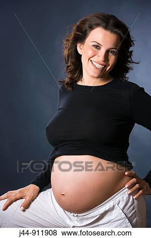 Stock Photo - Hispanic pregnant woman, smiling, portrait. Fotosearch