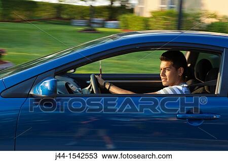Hispanic teenage boy driving car View Large Photo Image Stock Image - Hispanic teenage boy driving car. Fotosearch