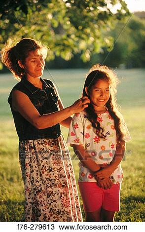 Hispanic woman combing out her daughter's hair. Somerville. Massachusetts. USA View Large Photo Image Stock Image - Hispanic woman combing out her daughter's hair. Somerville. Massachusetts. USA. Fotosearch