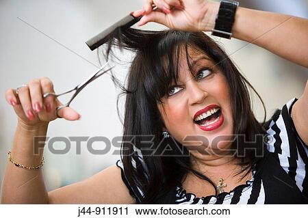 Hispanic woman cutting her hair, smiling, portrait View Large Photo Image Stock Image - Hispanic woman cutting her hair, smiling, portrait. Fotosearch