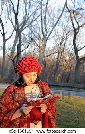 Stock Image - Hispanic woman in park. Fotosearch