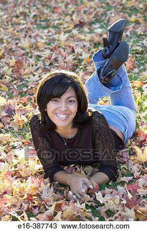 Hispanic woman laying in autumn leaves View Large Photo Image Stock Image - Hispanic woman laying in autumn leaves. Fotosearch