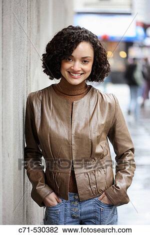 Hispanic woman smiling into camera View Large Photo Image Stock Image - Hispanic woman smiling into camera. Fotosearch
