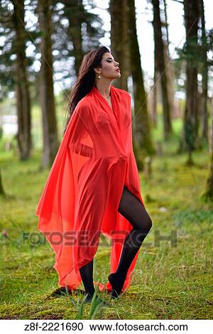 Hispanic woman with a red cloak, recreating a modern fairy tale of Little Red Riding Hood. View Large Photo Image Stock Image - Hispanic woman with a red cloak, recreating a modern fairy tale of Little Red Riding Hood.. Fotosearch