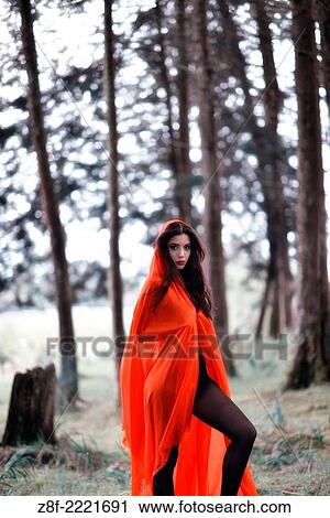 Hispanic woman with a red cloak, recreating a modern fairy tale of Little Red Riding Hood. View Large Photo Image Stock Image - Hispanic woman with a red cloak, recreating a modern fairy tale of Little Red Riding Hood.. Fotosearch