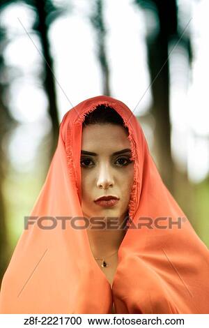 Hispanic woman with a red cloak, recreating a modern fairy tale of Little Red Riding Hood. View Large Photo Image Stock Image - Hispanic woman with a red cloak, recreating a modern fairy tale of Little Red Riding Hood.. Fotosearch