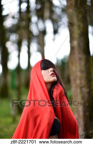 Hispanic woman with a red cloak, recreating a modern fairy tale of Little Red Riding Hood. View Large Photo Image Stock Image - Hispanic woman with a red cloak, recreating a modern fairy tale of Little Red Riding Hood.. Fotosearch