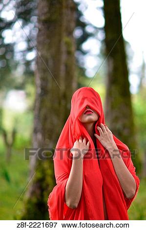 Hispanic woman with a red cloak, recreating a modern fairy tale of Little Red Riding Hood. View Large Photo Image Stock Photo - Hispanic woman with a red cloak, recreating a modern fairy tale of Little Red Riding Hood.. Fotosearch