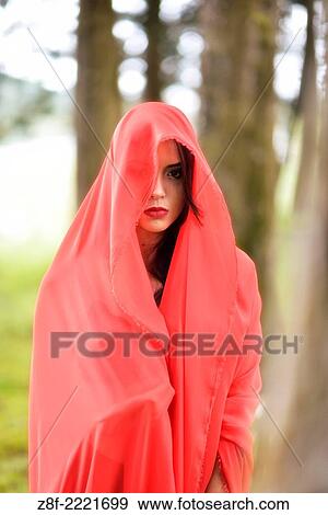 Hispanic woman with a red cloak, recreating a modern fairy tale of Little Red Riding Hood. View Large Photo Image Stock Photo - Hispanic woman with a red cloak, recreating a modern fairy tale of Little Red Riding Hood.. Fotosearch