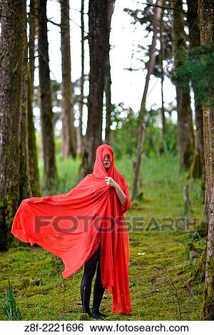 Hispanic woman with a red cloak, recreating a modern fairy tale of Little Red Riding Hood. View Large Photo Image Stock Photograph - Hispanic woman with a red cloak, recreating a modern fairy tale of Little Red Riding Hood.. Fotosearch