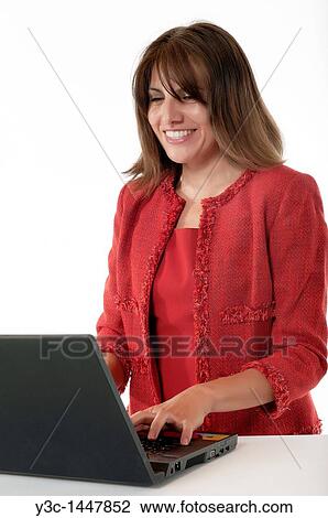 Hispanic woman working at a computer View Large Photo Image Stock Image - Hispanic woman working at a computer. Fotosearch