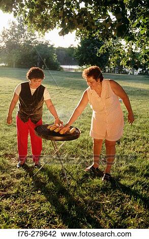 Hispanic women cooking corn on grill. Chelsea. Massachusetts. USA View Large Photo Image Stock Image - Hispanic women cooking corn on grill. Chelsea. Massachusetts. USA. Fotosearch