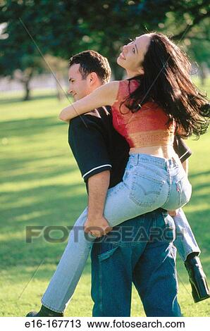 Stock Image - Hispanic young adults in park. Fotosearch