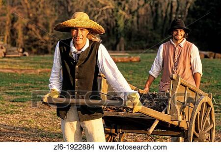 Picture - Historical Colonial America in Williamsburg Virginia with male actors in costume acting out history. Fotosearch