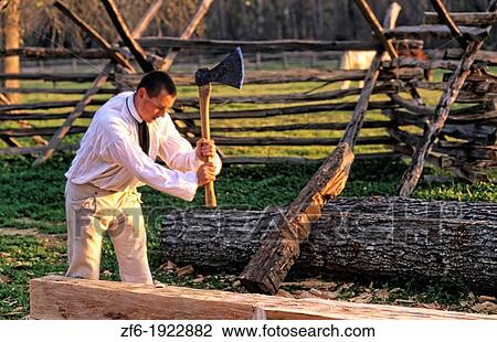 Stock Image - Historical Colonial America in Williamsburg Virginia with male actors in costume acting out history. Fotosearch