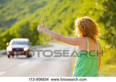 Hitch hiking young woman View Large Photo Image Picture - Hitch hiking young woman. Fotosearch